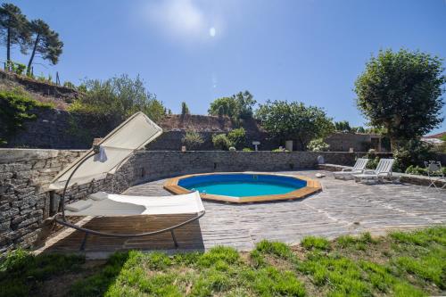 a swimming pool with two lounge chairs at Quinta Da Estrada Winery Douro Valley in Peso da Régua