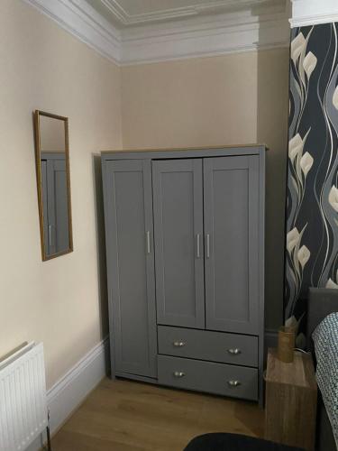 a gray cabinet in a room with a mirror at Crystal in Crystal Palace
