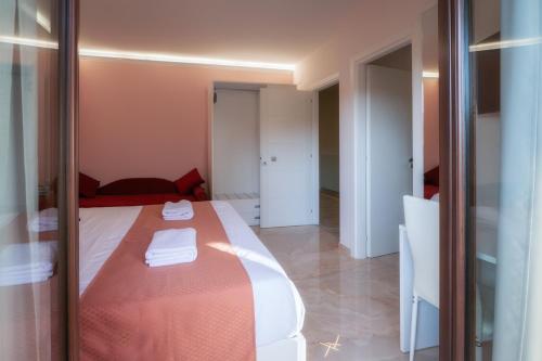a bedroom with a bed with a red blanket at La Perla Nascosta in Belvedere Marittimo