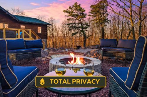 a patio with a fire pit and furniture and a house at Skypine Lodge - Log Lodge Atop the World in Jim Thorpe