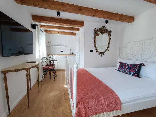 a bedroom with a white bed with a red blanket at M&R Apartments II in Koper