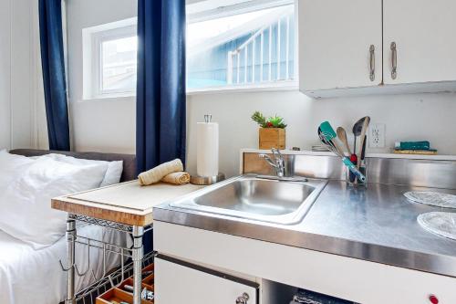 a kitchen with a sink next to a bed at Balboa Beauty III in Newport Beach