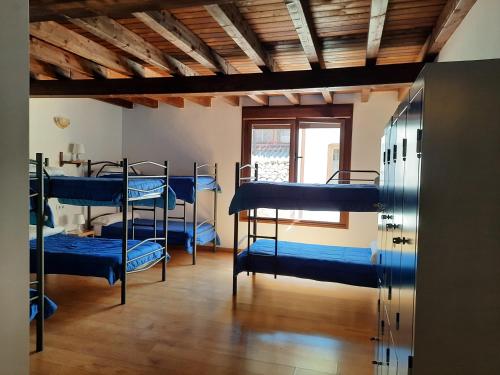 a room with four bunk beds in it at La Casa de Mi Abuela in Aldeanueva del Camino