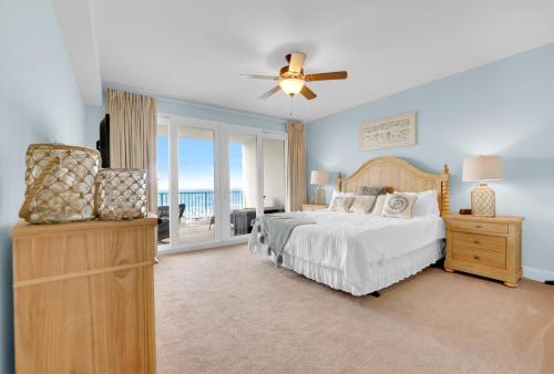 a bedroom with a bed and a balcony with the ocean at The Blue Turtle at Laketown Wharf in Panama City Beach