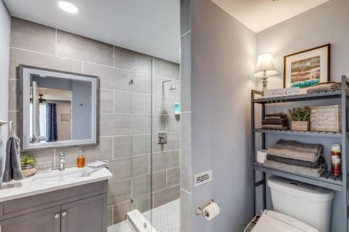 a bathroom with a toilet and a sink and a mirror at StockYards-BBobs-4mins! GrayLee House.4-Bedrooms in Fort Worth