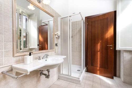 y baño con lavabo, ducha y espejo. en Comfort Rooms Villa Gaia Tor Vergata, en Roma