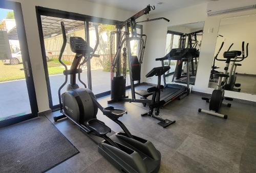a gym with several tread machines in a room at Hotel Oasis-Dream Holidays - La Petite France in San Bernardino