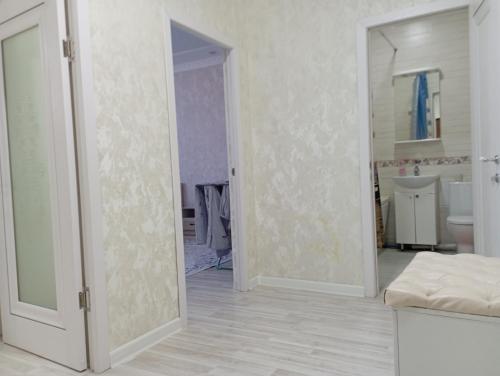 a room with a door open to a bathroom at ЖК Арай in Aktobe