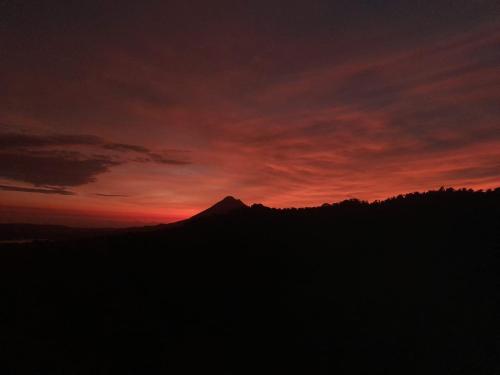 a silhouette of a mountain with a sunset in the background at Finca Del Cielo in El Castillo de la Fortuna