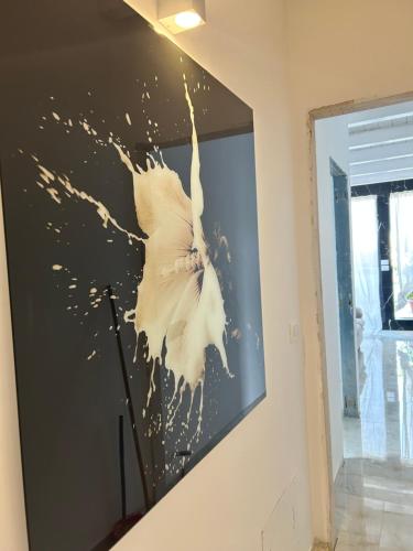a large painting of a white bird on a wall at Blumoon boutique in Andria