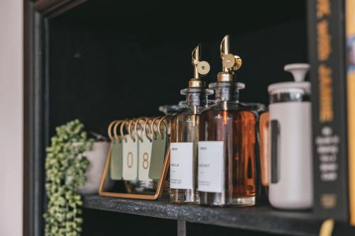 a shelf with several bottles of soap and scissors at House with a cinema and games room, sleeps 17 in Shrewsbury