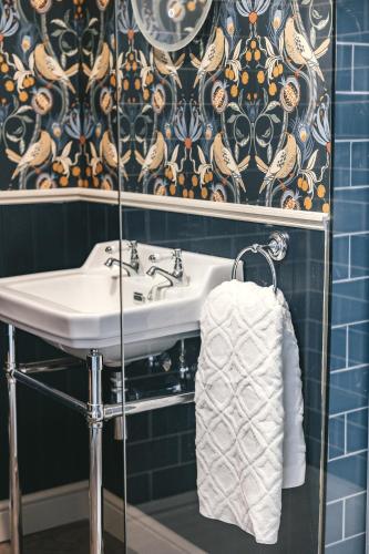 a bathroom with a sink and a towel at House with a cinema and games room, sleeps 17 in Shrewsbury