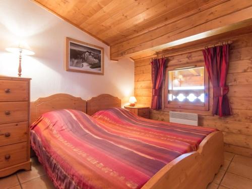 a bedroom with a bed in a log cabin at Appartement Les Arcs 1800, 4 pièces, 7 personnes - FR-1-346-334 in Arc 1800