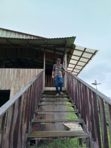 a man standing on the stairs of a bridge at Finca Del Cielo in El Castillo de la Fortuna