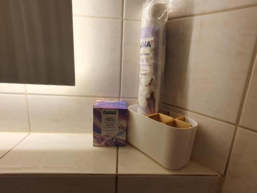 a bathroom counter with a box of soap and a bag of toilet paper at Apartement Weingarten in Weingarten