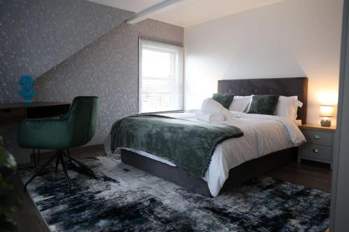 a bedroom with a bed and a desk and a chair at K&i Lakeside Retreat in Southport