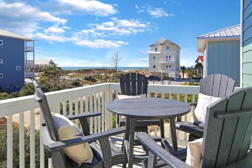 a table and chairs on a balcony with a view of the ocean at Havin A Blas by Pristine Properties Vacation Rentals in Cape San Blas