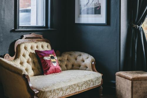a chair with a pillow on it in a room at House with a cinema and games room, sleeps 17 in Shrewsbury
