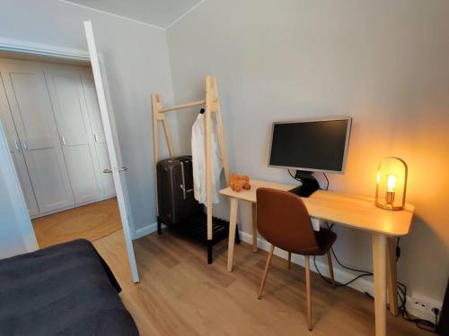 a bedroom with a desk with a computer on it at Room Aria in Savonlinna