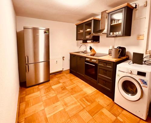 a kitchen with a refrigerator and a washer and dryer at Cologne LUXE Living: Opulent Elegance Unleashed in Cologne
