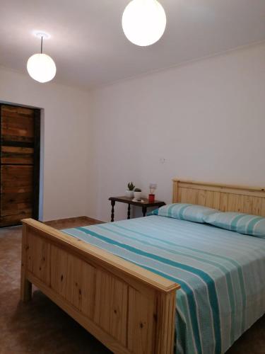 a bedroom with a large bed with a blue blanket at La Rosa dei Venti in Colorado River
