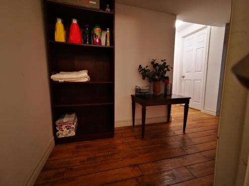 a room with a desk and a table in a room at one queen-sized bed convenient location in Toronto