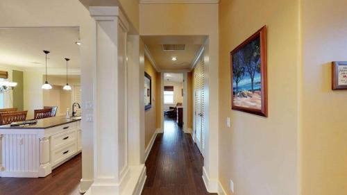 a hallway of a home with a kitchen and dining room at Elegant Poolside Penthouse w Private Elevator in Koloa