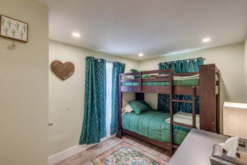 two bunk beds in a room with a heart on the wall at StockYards! Less than 4 minutes-Sleeps 8-Lee House in Fort Worth