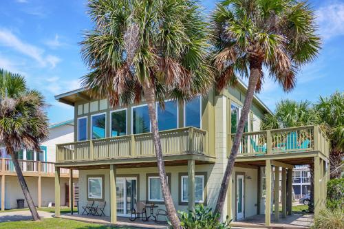 a house with palm trees in front of it at Beach View Upper by Pristine Properties Vacation Rentals in Mexico Beach