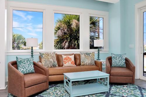 a living room with a couch and two chairs at Beach View Upper by Pristine Properties Vacation Rentals in Mexico Beach