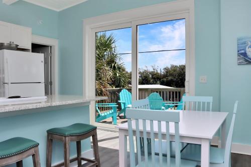 a kitchen and dining room with a table and chairs at Beach View Upper by Pristine Properties Vacation Rentals in Mexico Beach