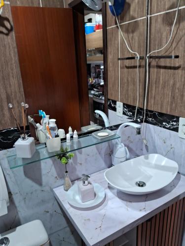 a bathroom with a sink and a mirror at Hospedom Mazzoca 02 , WC compartilhado in Itapema