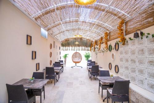 a dining room with tables and chairs and a ceiling at ikarushotel in Aydın