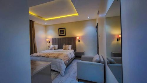 a hotel room with a bed and a couch at Abados Leisure Hotel and Lounge in Lagos