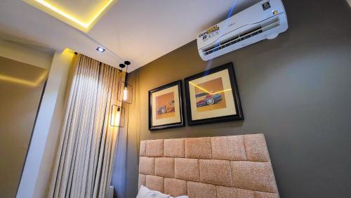 a bedroom with a bed and a air conditioner on the wall at Abados Leisure Hotel and Lounge in Lagos