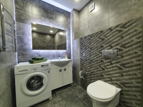 a bathroom with a washing machine and a sink at Батыс LUX in Aktobe