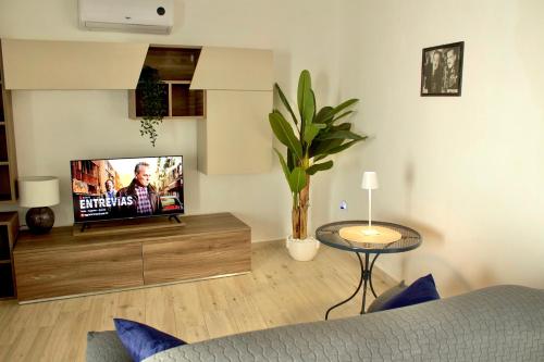 a living room with a flat screen tv on a wooden entertainment center at Casa Moderna in Olbia