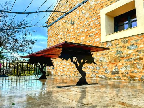 a bench in front of a brick building at Villa Napoléon Piscine&Jacuzzi in Le Somail