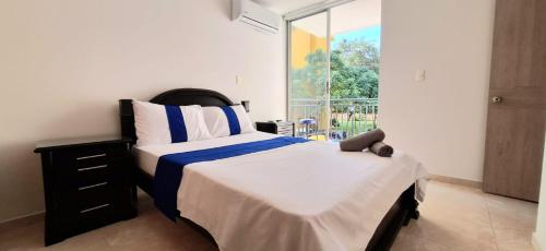 Säng eller sängar i ett rum på CB2 Somos AT HOME Apto tranquilo con Aire Acondicionado