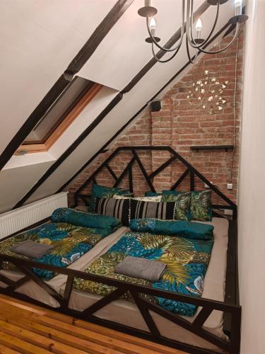 a bed in a room with a brick wall at Casa Anne Boutique in Braşov