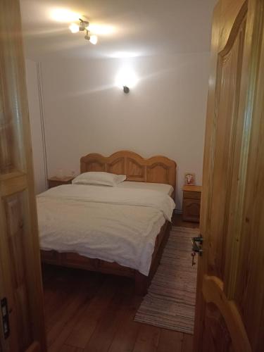 a bedroom with a bed and a light on the ceiling at Casa Galeata in Nehoiu