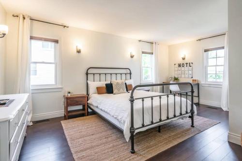 a bedroom with a black bed in a room at Boho Inspired NOTL Wine Country Private Home for 2 in Niagara-on-the-Lake