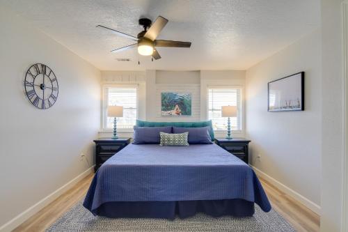 a bedroom with a blue bed with a ceiling fan at Waterfront Kingston Apartment with River Access! in Kingston