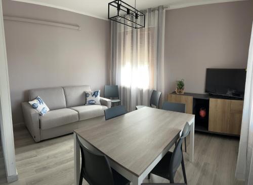 a living room with a table and a couch at Venice Queen Apartments in Cavallino-Treporti