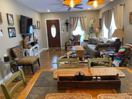 a living room filled with lots of furniture at StockYards!-1 block away ! Cowboy Cottage sleeps 9 in Fort Worth