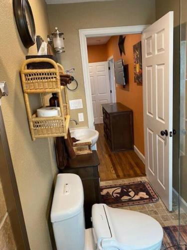 a bathroom with a toilet and a sink at StockYards!-1 block away ! Cowboy Cottage sleeps 9 in Fort Worth