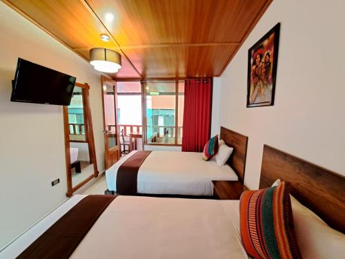 Postel nebo postele na pokoji v ubytování Inti Pacha Palace Machupicchu