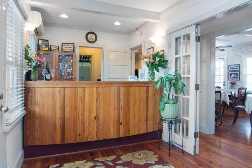 a lobby with a counter with flowers on it at First Colony Inn in Nags Head