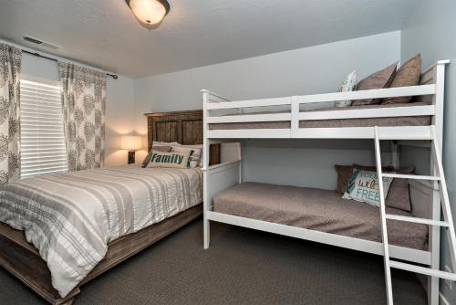 a bedroom with two bunk beds and a bed at Desert Cool in Ivins