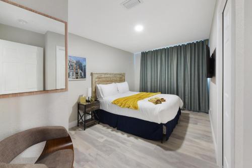 a hotel room with a bed and a mirror at Palm Cove Motel in Clearwater